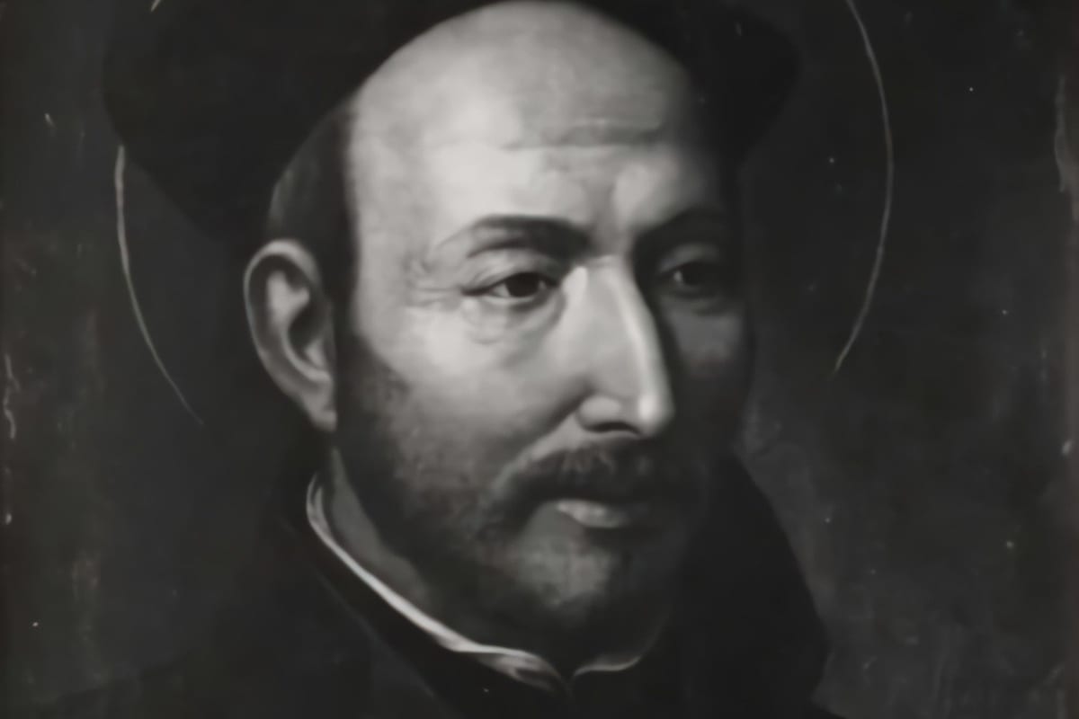 A bust-length portrait in dark oil tones of an elderly bald man with a short grey beard, wearing a black cap and dark cassock, a faint halo outlined behind his head, gazing slightly to the side.