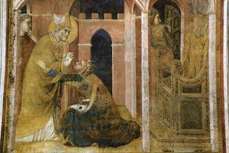 A medieval fresco showing a haloed bishop in gold vestments and a white mitre laying his hand on a kneeling crowned figure in an arched courtyard, with two onlookers at the edges.