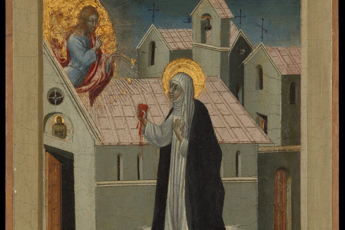 A trecento-style panel painting of a haloed nun in a black-and-white Dominican habit standing before a cluster of church buildings, holding up a small red heart toward Christ, who appears in a golden mandorla at the upper left with rays streaming down onto the rooftops.