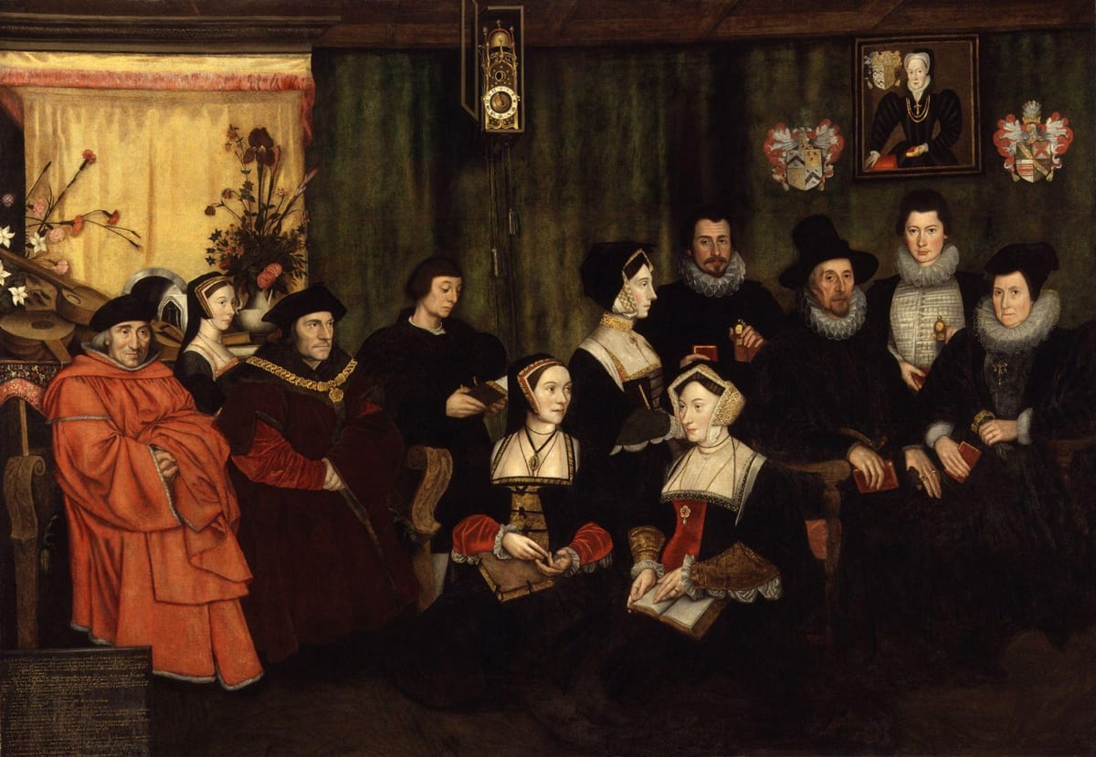 A crowded oil painting of an Elizabethan-dress family group in a wood-panelled room, with St. Thomas More, wearing a red robe and gold chain of office, standing among his father, wife, children and descendants.