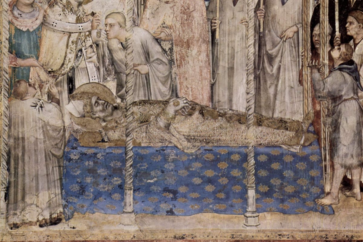 A fresco showing the shrouded body of St. Martin of Tours laid out on a bier draped in blue and gold cloth, a bishop bending to bless him with a censer as mourners in albs and habits stand around holding tall candles.