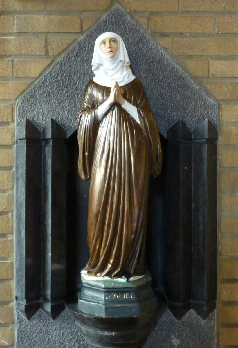 A photograph in the church of Sainte-Alice at Schaerbeek showing the parish image of St. Alice as a veiled Cistercian in white under a black veil.