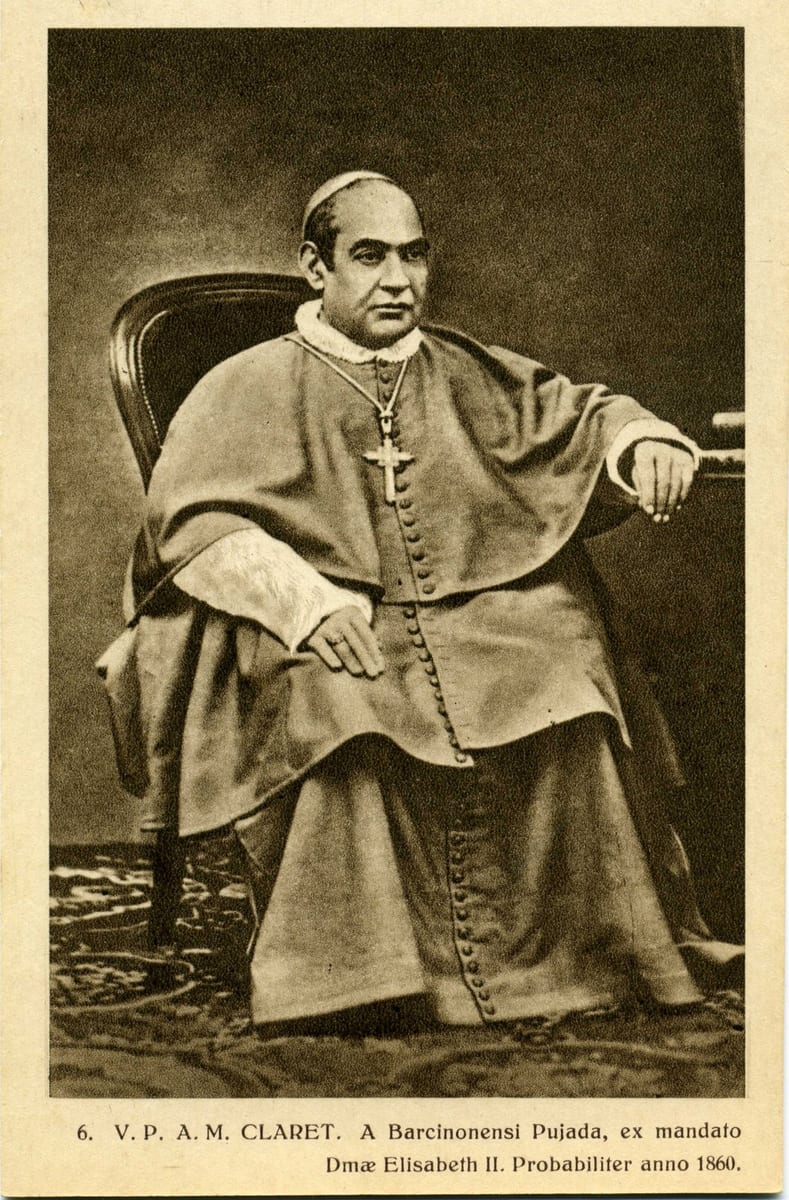 A seated, balding Catholic archbishop in the vestments and pectoral cross of his office, one hand resting on his knee and the other on the arm of a carved wooden chair, in a studio photograph from around 1860.