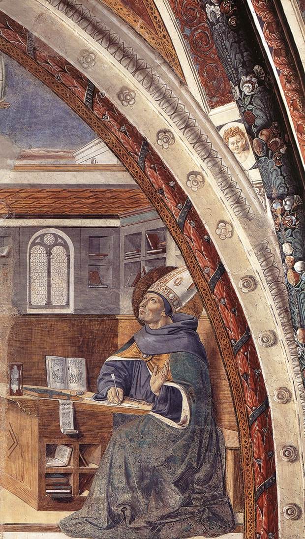 An aged, white-haired man bends over a writing desk with a book open on a lectern before him.
