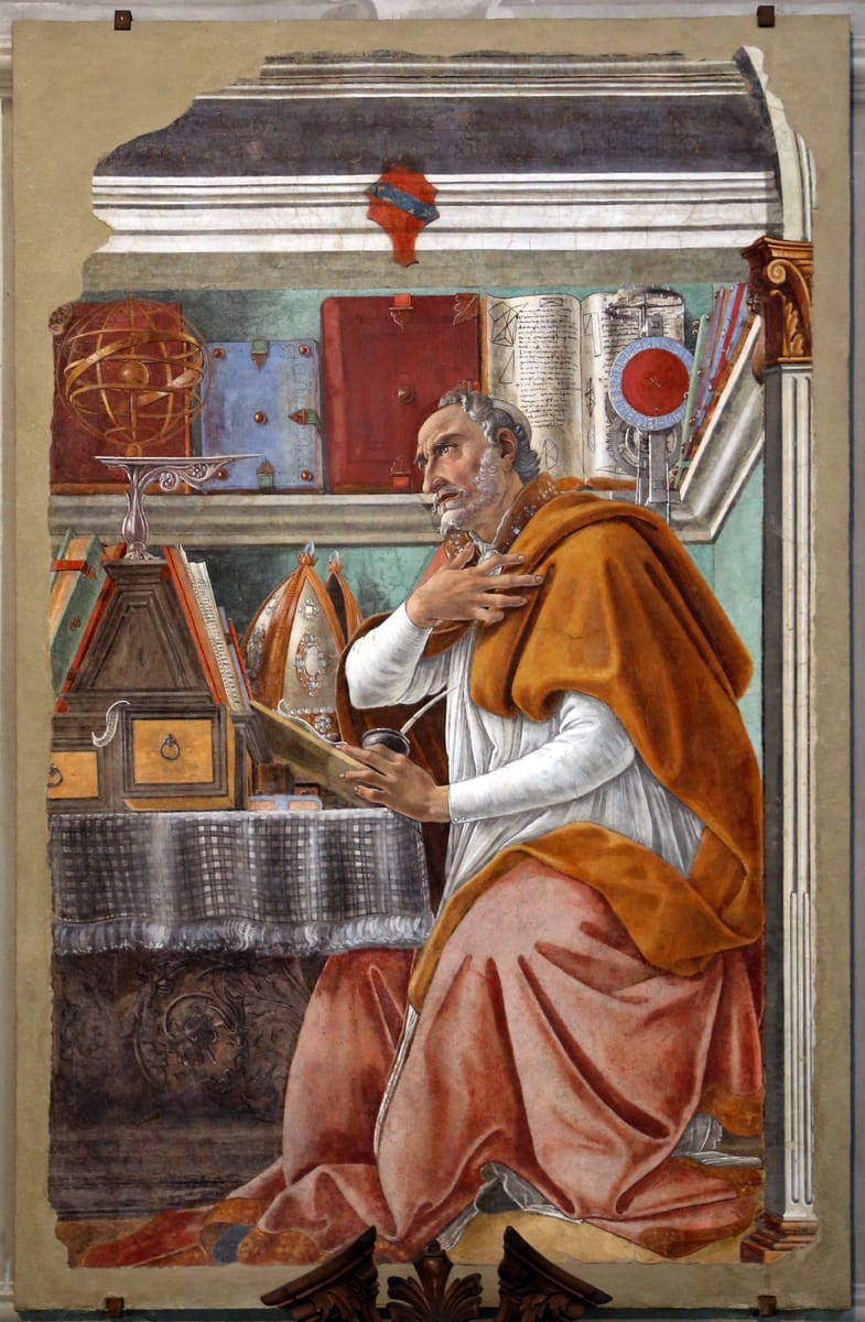 An elderly bishop sits at a book-laden desk in his study, one hand pressed to his chest and his gaze lifted.