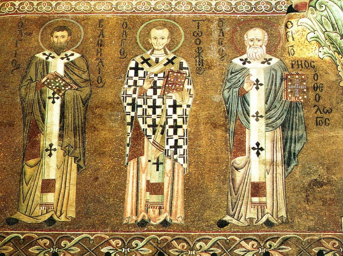A gold-ground mosaic at Cefalu shows Saint Basil the Great standing with Saint Gregory of Nazianzus and Saint John Chrysostom, each vested and named in Greek.