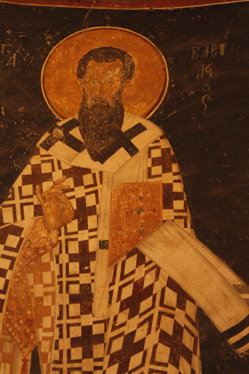 A fresco in the Chora church at Constantinople shows Saint Basil bare-headed and drawn, with a long pointed beard streaked grey, vested in the phelonion and the white omophorion of a bishop.