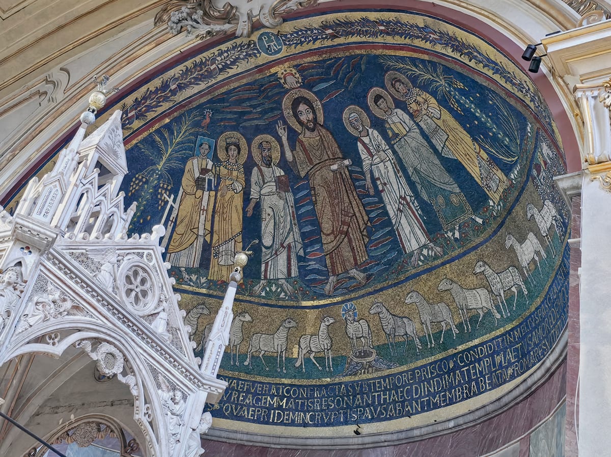 In the apse mosaic Christ in majesty blesses at the centre, with Saint Paul, Saint Cecilia and Pope Paschal I holding a model of the church on one side and Saint Peter, Saint Valerian and Saint Agatha on the other, and St. Cecilia laying her hand on the pope's shoulder.