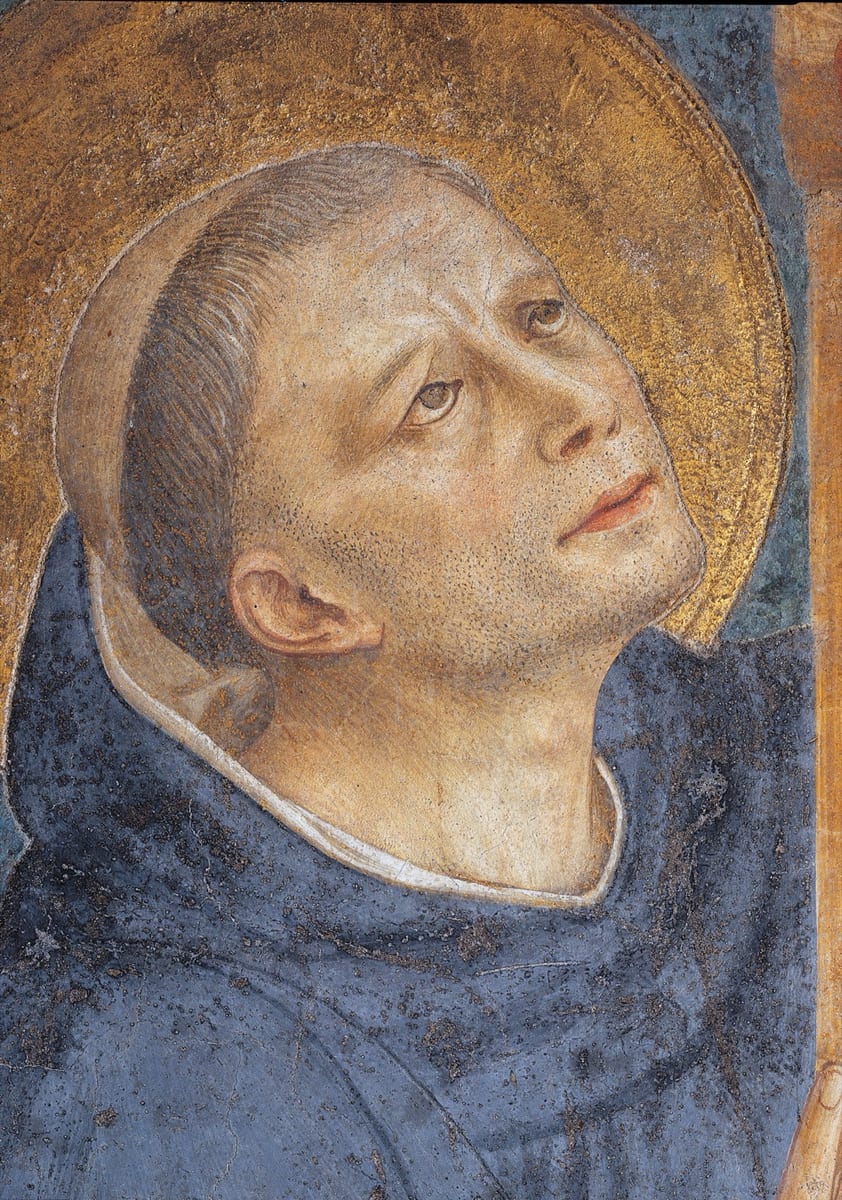 A painted head of St. Dominic, tonsured and tilted back, his eyes turned upward.