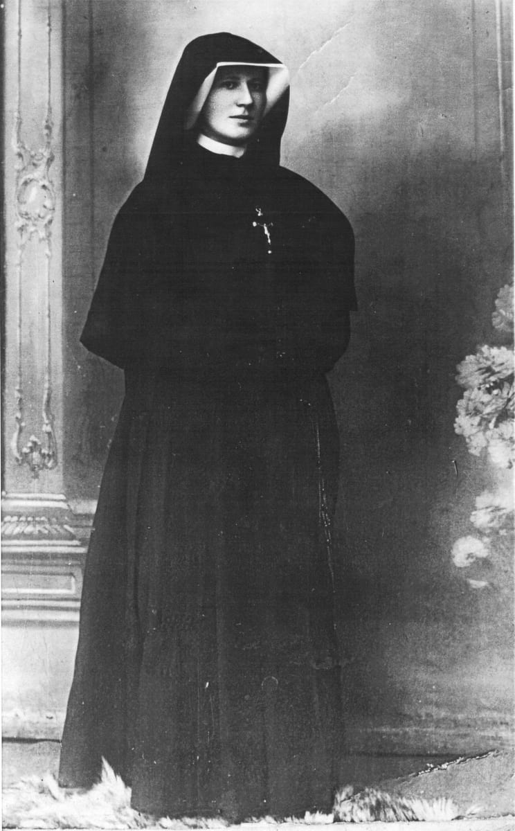 A photograph of Sister Faustina taken at Płock in 1931 AD, in the black habit and veil of the Sisters of Our Lady of Mercy, with a white collar at the throat and a crucifix at her breast.