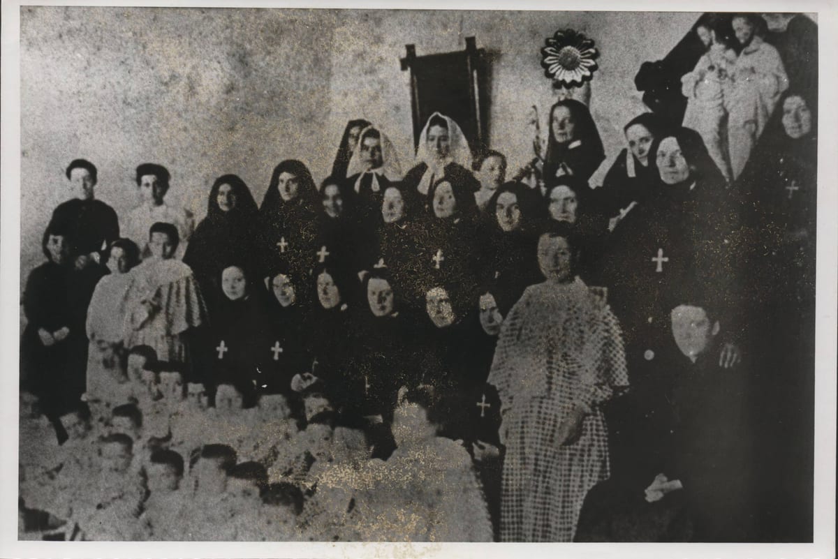 The Missionary Sisters of the Sacred Heart of Jesus photographed with the orphans of their New York orphanage about 1890 AD, St. Frances Xavier Cabrini in the back row beside two postulants in white veils.
