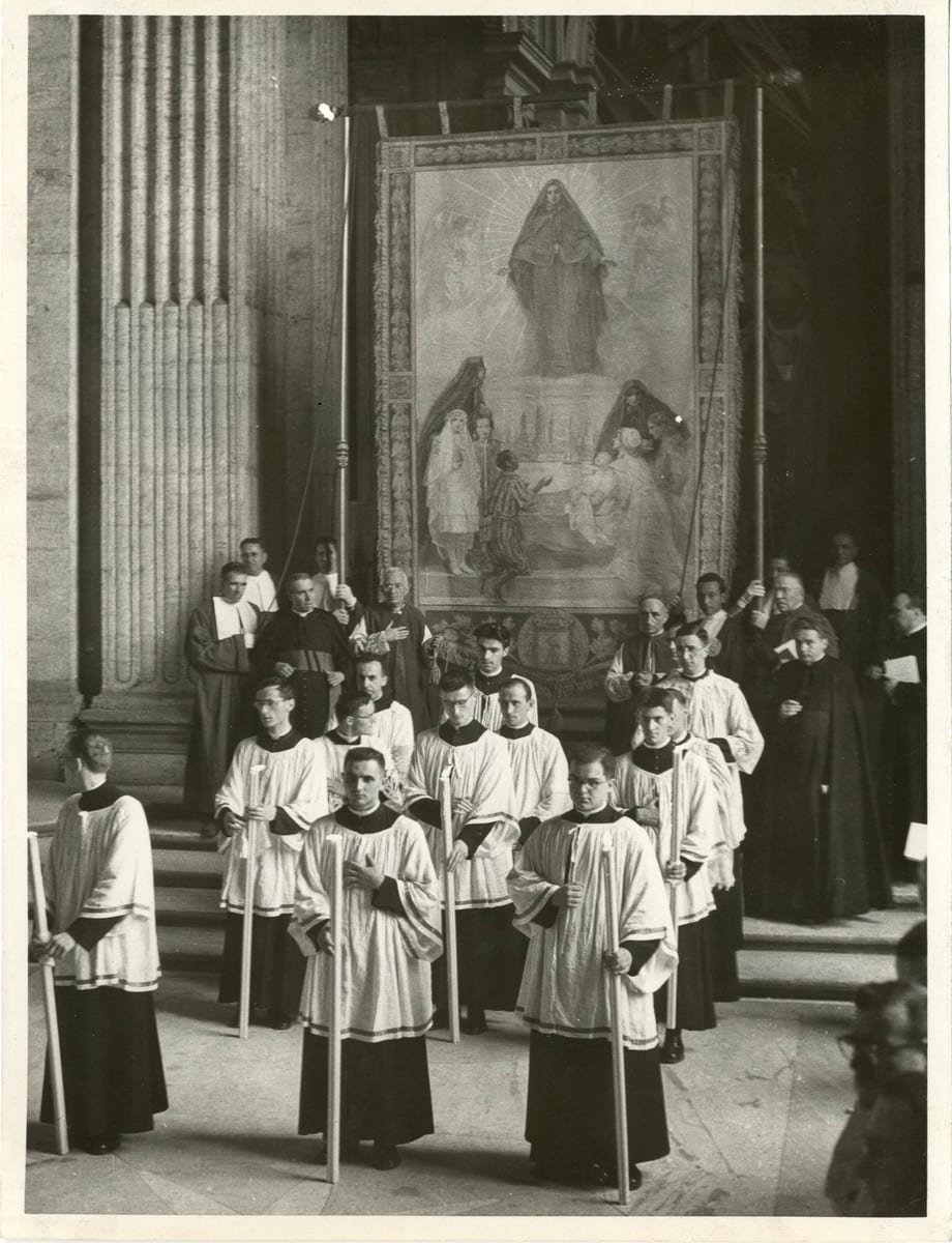 Seminarians carrying lighted candles in the canonization procession in St Peter's Basilica on July 7, 1946 AD, beneath a tapestry depicting St. Frances Xavier Cabrini.