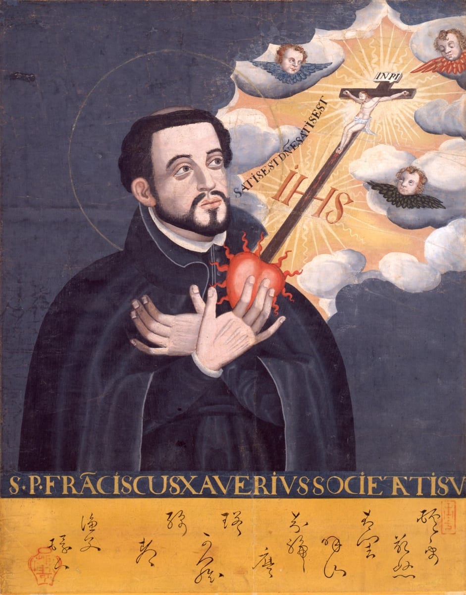 A painting of a dark-robed priest with a white collar, gazing upward with his hands pressed to a flaming red heart, beneath a crucifix with the letters IHS in a radiant cloud of angels.