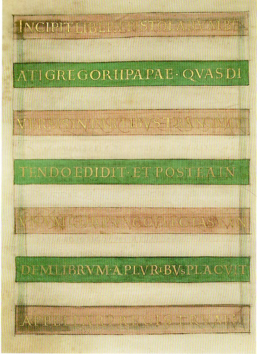 An illuminated manuscript page from the Registrum Gregorii showing an ornate Latin inscription in gold lettering, its lines set against alternating bands of rose-pink and green, opening the register of St. Gregory the Great's letters.
