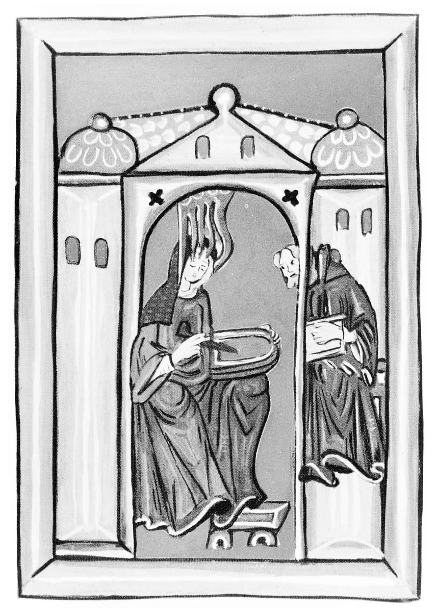 A medieval miniature shows St. Hildegard seated in a vaulted stone chamber with a wax tablet on her knee and a stylus in her hand, five tongues of flame descending on her head, while the monk Volmar writes in the opening at her side.