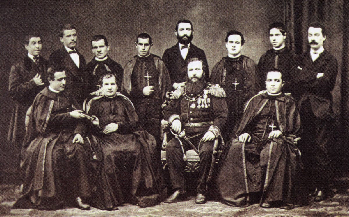Group photograph of November 1875 AD with St. John Bosco seated among the first Salesian missionaries, beside the uniformed Argentine consul.