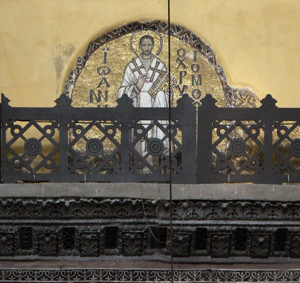 A ninth-century mosaic tondo in the north tympanum of Hagia Sophia shows Saint John Chrysostom with a high bald forehead, short dark hair at the sides, hollow cheeks and a thin wedge-shaped beard.