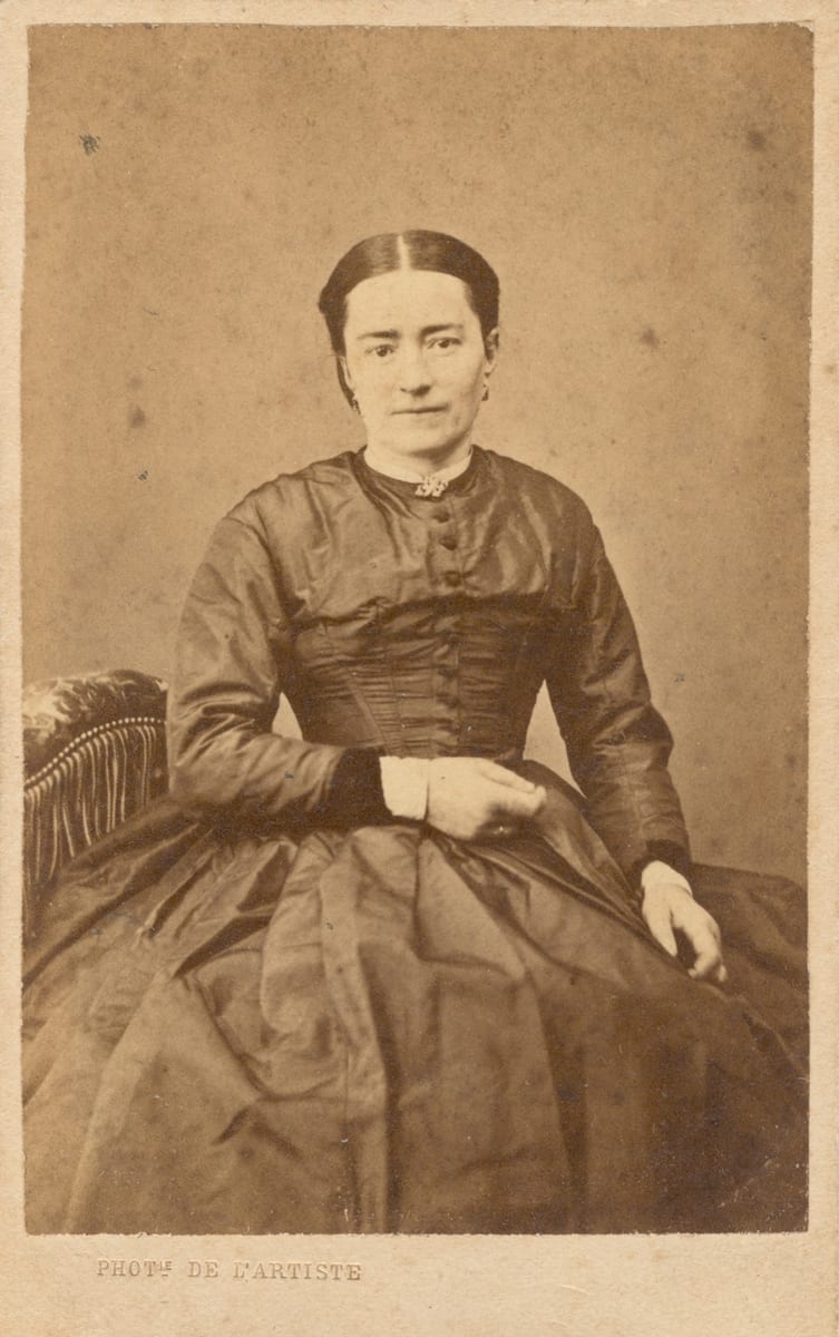 St. Zélie Martin seated in a dark silk dress with her hands in her lap, in a studio carte de visite from about 1875 AD.