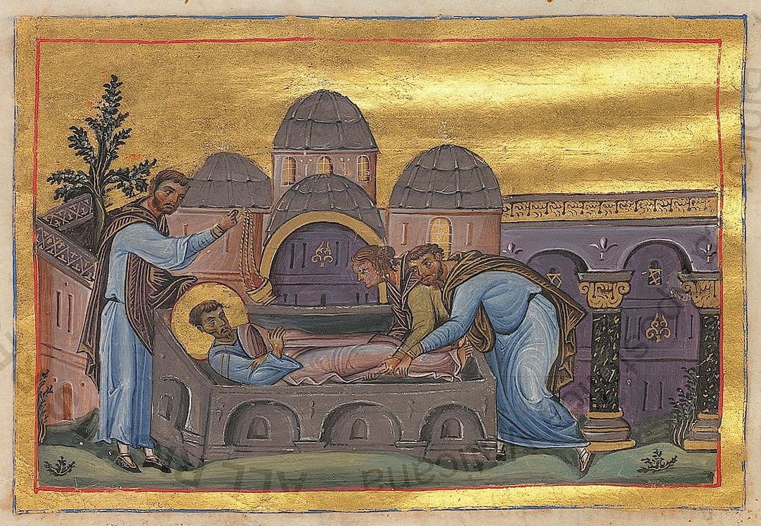 A tenth-century Byzantine miniature of St. Luke's body being lowered into a stone sarcophagus while a bearded man swings a censer under a gold sky.
