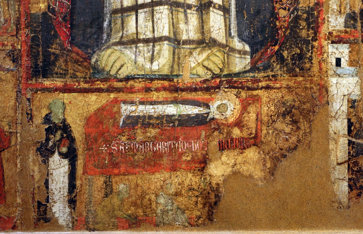 In a medieval panel painting, St. Margaret's haloed body lies wrapped in white on a bier draped in red, with her name written in white capitals across the cloth.