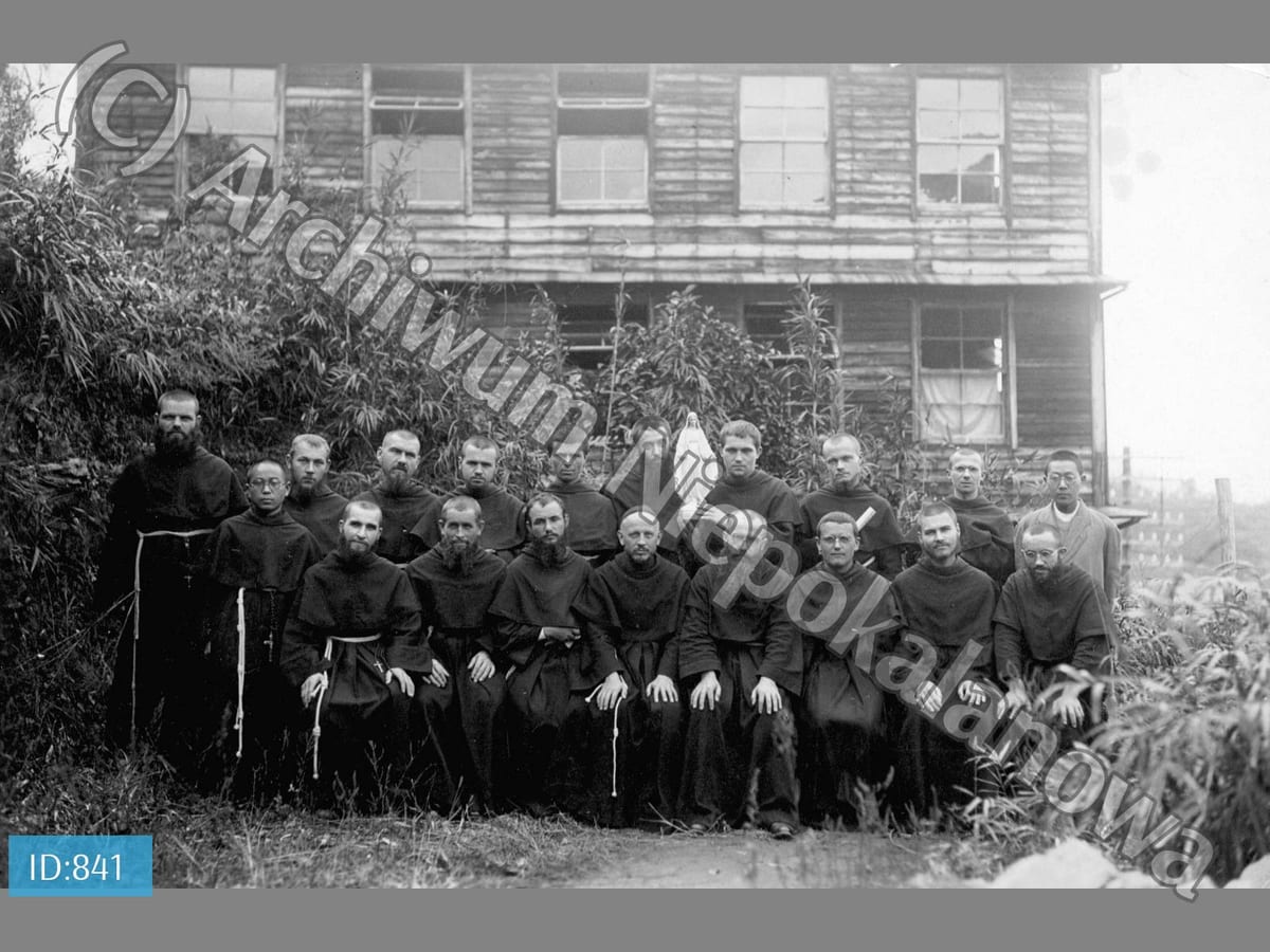 Polish friars, Japanese brothers and seminarians together outside the wooden mission house on the hillside at Nagasaki.
