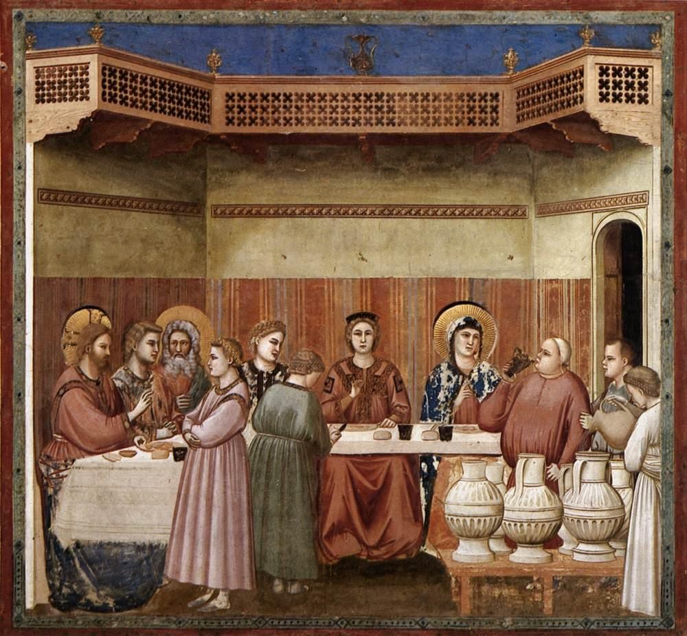 Giotto's painting of the wedding at Cana, with Christ blessing at the left of the table, Our Lady in blue speaking to the steward as he tastes wine, and servants filling great jars at the right.