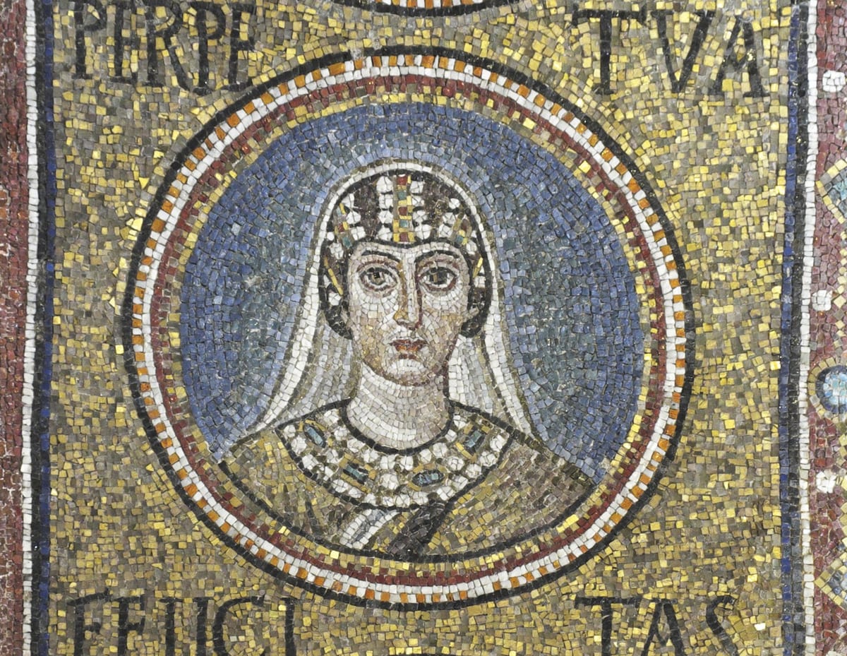 A sixth-century mosaic medallion bust portrait of Saint Perpetua, veiled and haloed against a blue background, with her name inscribed in Latin above and below, from the vault of the Archiepiscopal Chapel in Ravenna.