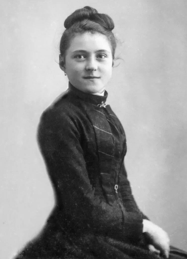 St. Thérèse at fifteen, her hair worn up and her dress dark and high-necked, photographed at a Lisieux studio in April 1888 AD.