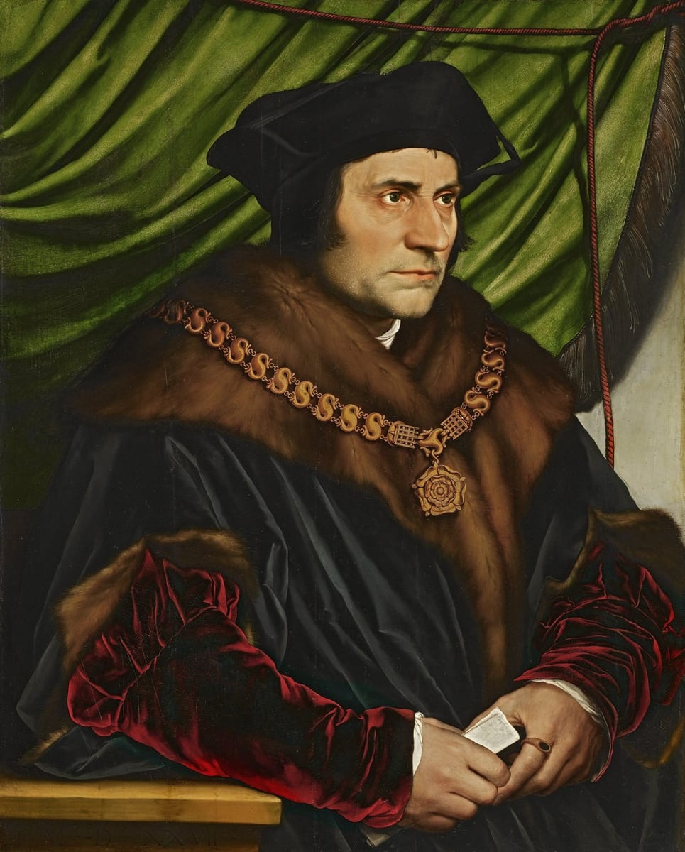 A half-length portrait of a bearded man in a black cap and fur-trimmed black robe over a red velvet sleeve, wearing a gold Tudor collar of esses with a Tudor rose pendant, holding a folded paper in his hands against a draped green curtain.